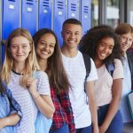 teenage-school-kids-smiling-to-camera-in-school-corridor.jpg
